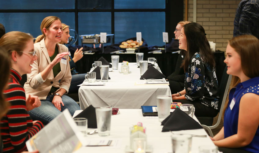 Mentors and mentees seated for dinner