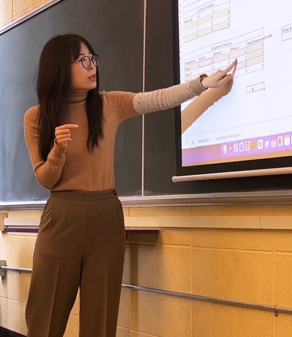 Professor Chayoue Zhao teaches in front of a classroom