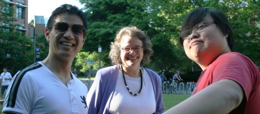 Three people standing outside smiling