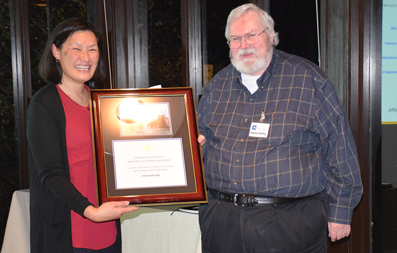 Linda Boyle handing a plaque to Steve Snelling