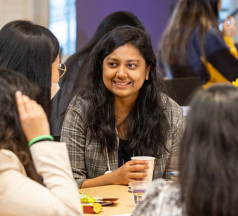 students of WE Rise chat around a table